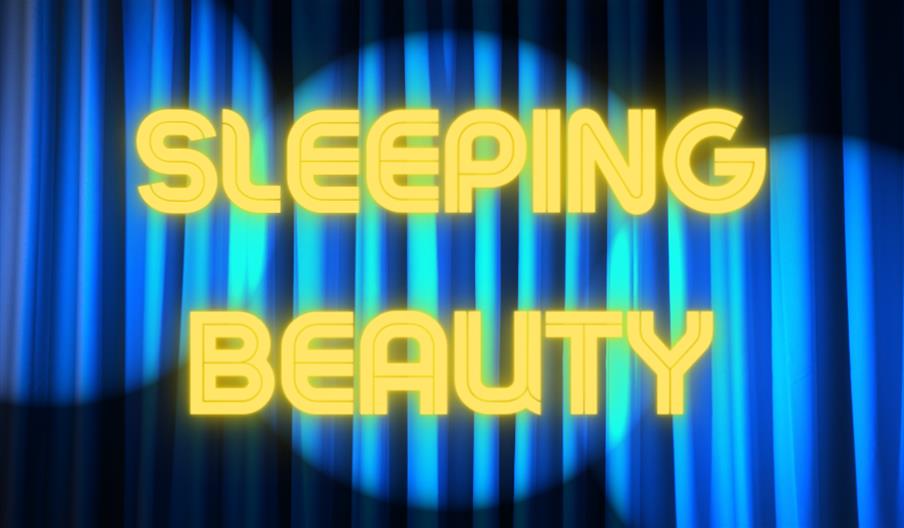 Sleeping Beauty sign in front of theatre curtains