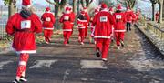 Back view of runners in the Santa Fun Run