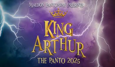 A purple background with lightning bolts on either side. In the center, the words "KING ARTHUR" are displayed in gold letters with a crown above. Belo